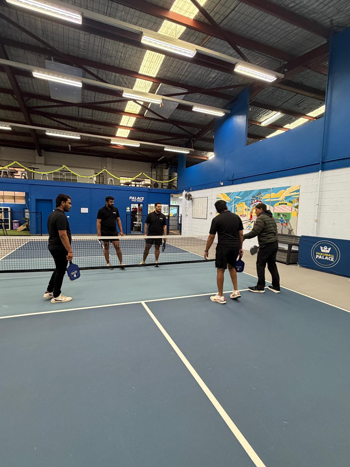 Shiners Group team members in action on the pickleball court